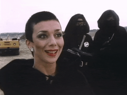 a woman in a black dress is smiling and says very good