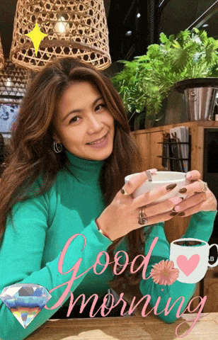a woman in a green turtleneck is holding a cup of coffee and says good morning in pink