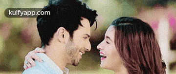 a man and a woman are looking at each other .