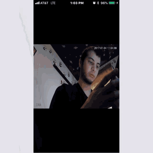 an at & t lte phone displays a picture of a man looking at his phone
