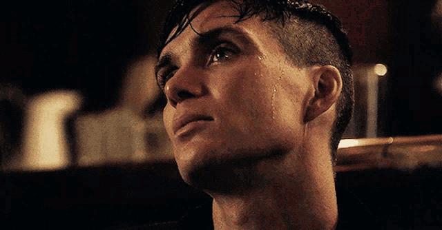 a close up of a man 's face with water coming out of his nose