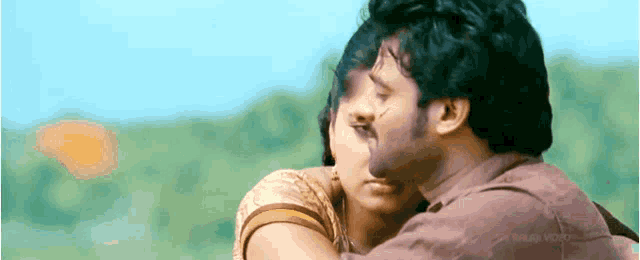 a man and a woman are hugging each other with a watermark that says ' sahara video ' on the bottom