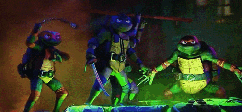 a group of teenage mutant ninja turtles standing next to each other holding weapons