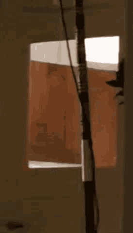 a blurred image of a person 's face is behind a window with a light on
