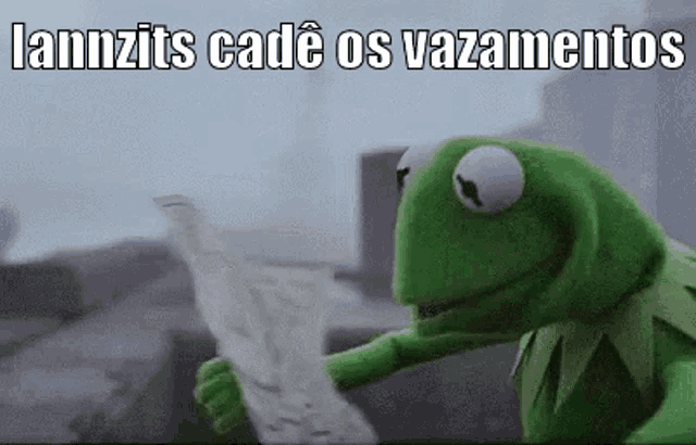 kermit the frog is holding a piece of paper with the words `` lannzits cadé os vazamentos '' written on it .