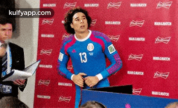 a soccer player with the number 13 on his shirt