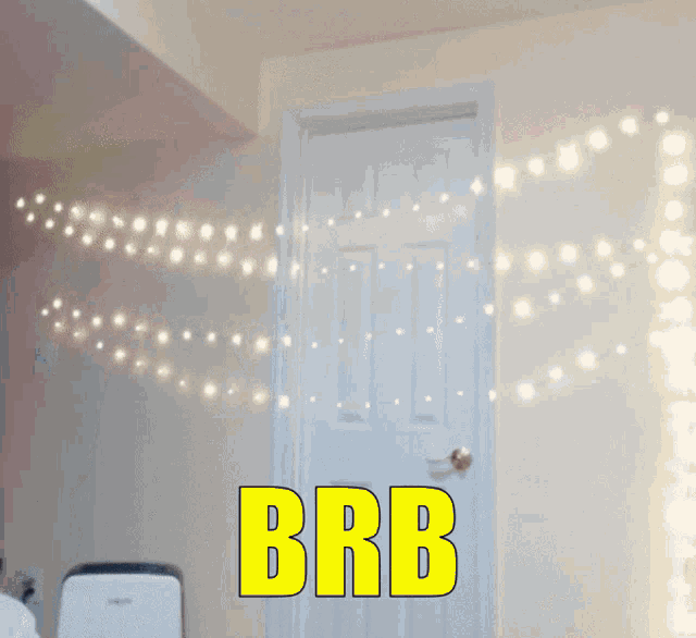 a door with a string of lights behind it and the words brb in yellow