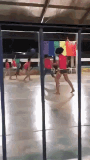 a group of people are playing a game in a gym
