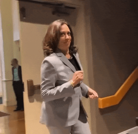 a woman in a suit is walking down the stairs .