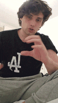 a man wearing a black shirt with a white la logo on it