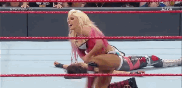 a woman is wrestling a man in a ring .