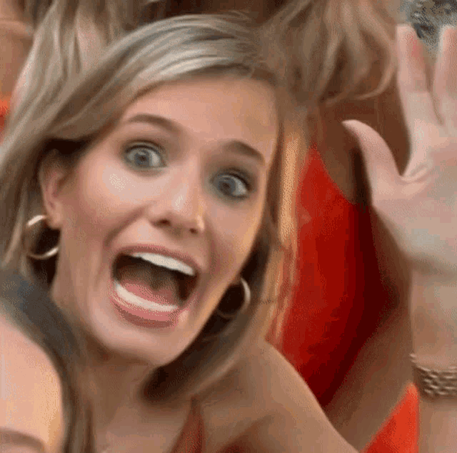 a close up of a woman 's face with her mouth wide open