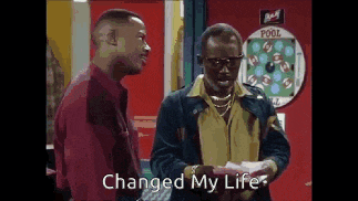 two men are standing next to each other and one of them is holding a piece of paper that says `` changed my life ''