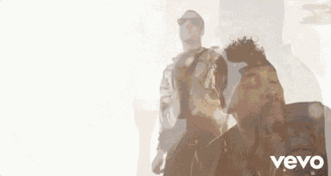 two men are standing next to each other in front of a white background .