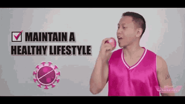 a man in a pink shirt is eating an apple with the words " maintain a healthy lifestyle " below him