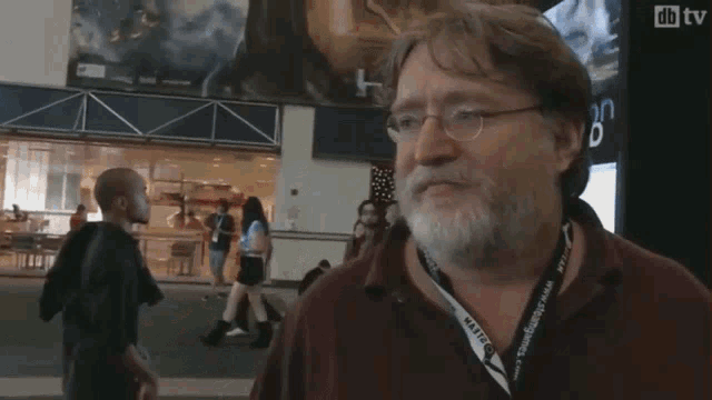 a man with a beard is being interviewed by someone with a microphone and a sign that says db tv