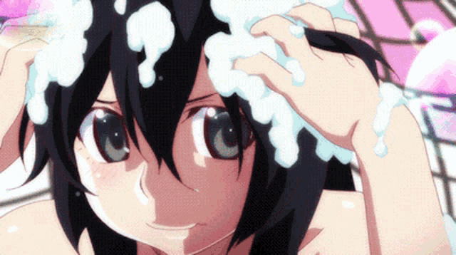 a girl with black hair is washing her hair with soap