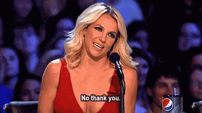 a woman in a red dress is sitting in front of a microphone and saying `` no thank you . ''