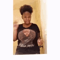 a woman wearing a black t-shirt that says melanin people