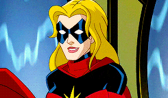 a cartoon of a woman in a superhero costume is smiling .