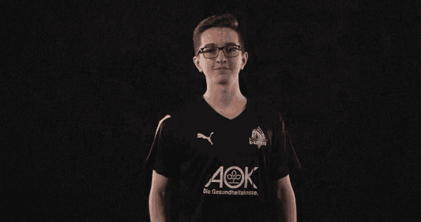 a young man wearing a black aok shirt