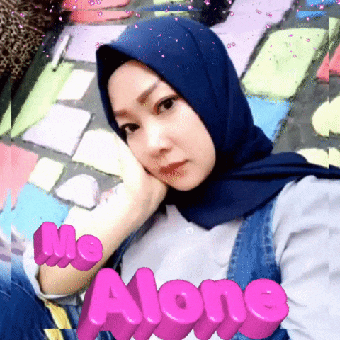 a woman wearing a blue hijab with the words " me alone " on the bottom right