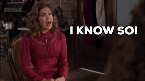 a woman in a red dress is sitting in a chair and says i know so