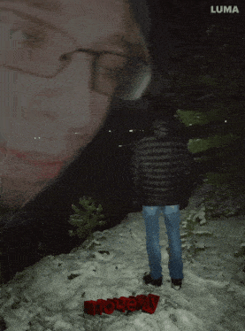 a man in a black jacket stands in the snow with a luma logo in the background