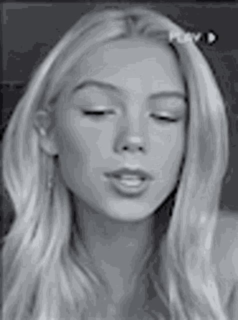 a black and white photo of a woman with long blonde hair .