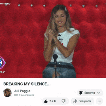 a video of a woman talking into a microphone is titled " breaking my silence "