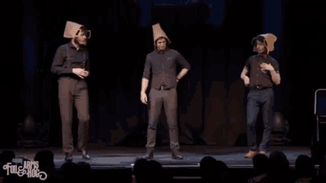 three men on a stage with the word her in yellow letters