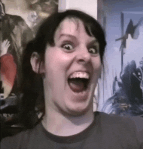 a woman is making a funny face with her mouth open in front of a painting .