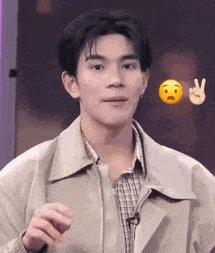 a man wearing a jacket and plaid shirt is making a peace sign with his hand