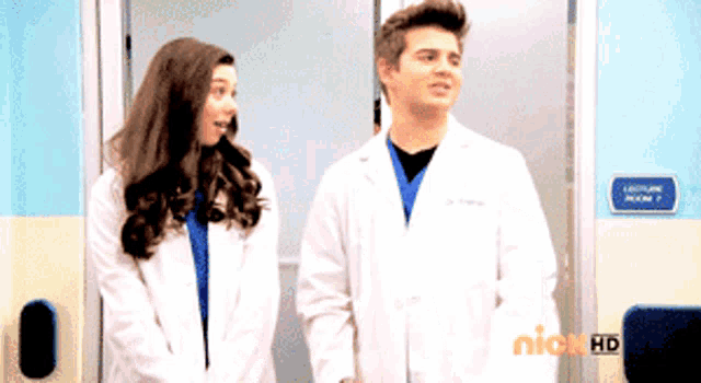 a man and a woman standing in front of a lecture room