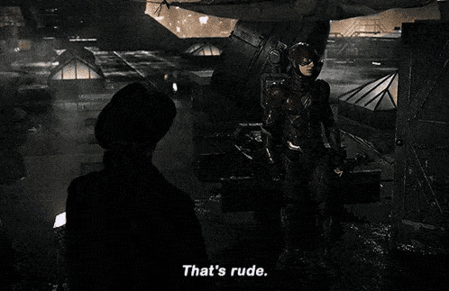 a man in a superhero costume is standing next to a woman in a hat and says that 's rude .