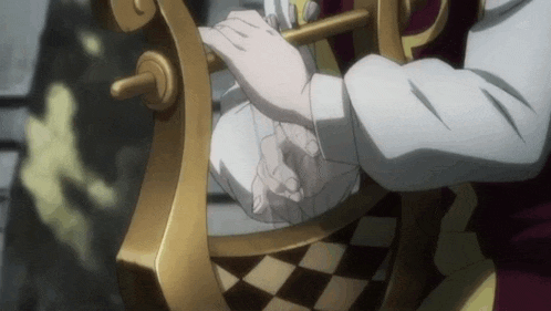 a person is sitting on a chair with their hands on a chess board .