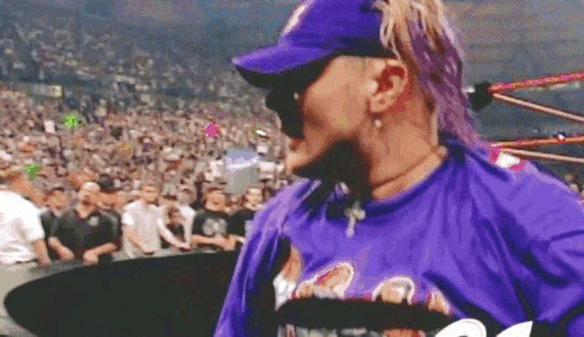 a man wearing a purple shirt and a purple hat