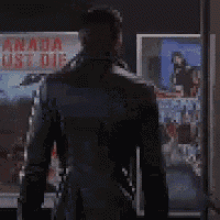 a man in a black coat is standing in front of a poster that says " armada lost die "