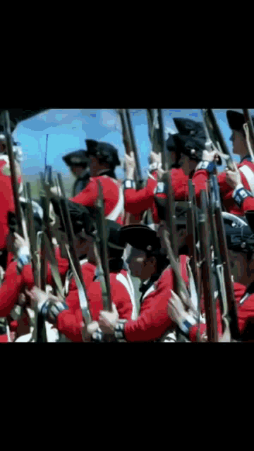a blurred image of soldiers in red uniforms holding guns