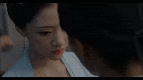 a close up of a woman looking at another woman .