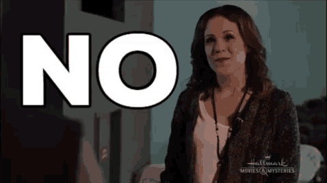 a woman stands in front of a sign that says " no "