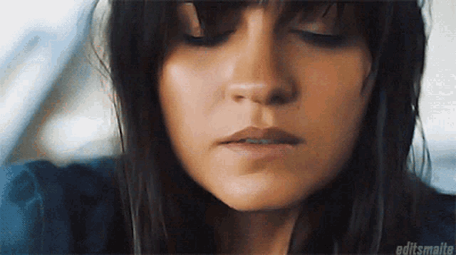 a close up of a woman 's face with editsmalte written on the bottom right