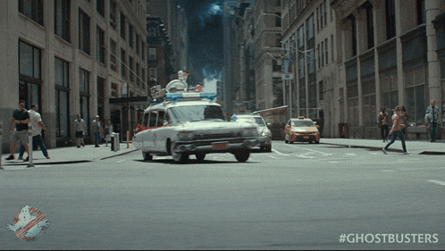 a ghostbusters car is driving down a busy city street