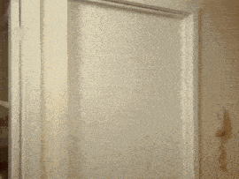 a close up of a white door with a brown trim