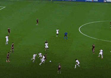 a group of soccer players on a field with one player wearing the number 18