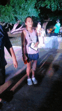 a woman wearing a pink tank top that says ' victoria 's secret ' on the front