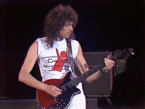 a man playing a guitar wearing a shirt that says " children need ice "