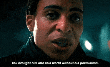 a close up of a person 's face with the words " you brought him into this world without his permission " below it