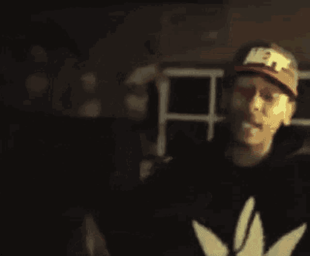 a blurry picture of a man wearing a hat and a black jacket .