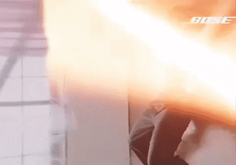 a person is standing in front of a wall with flames coming out of it
